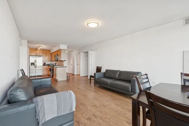 a living room with furniture and view of kitchen