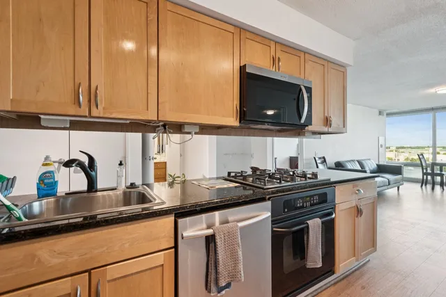 a kitchen with stainless steel appliances a sink a stove and a microwave