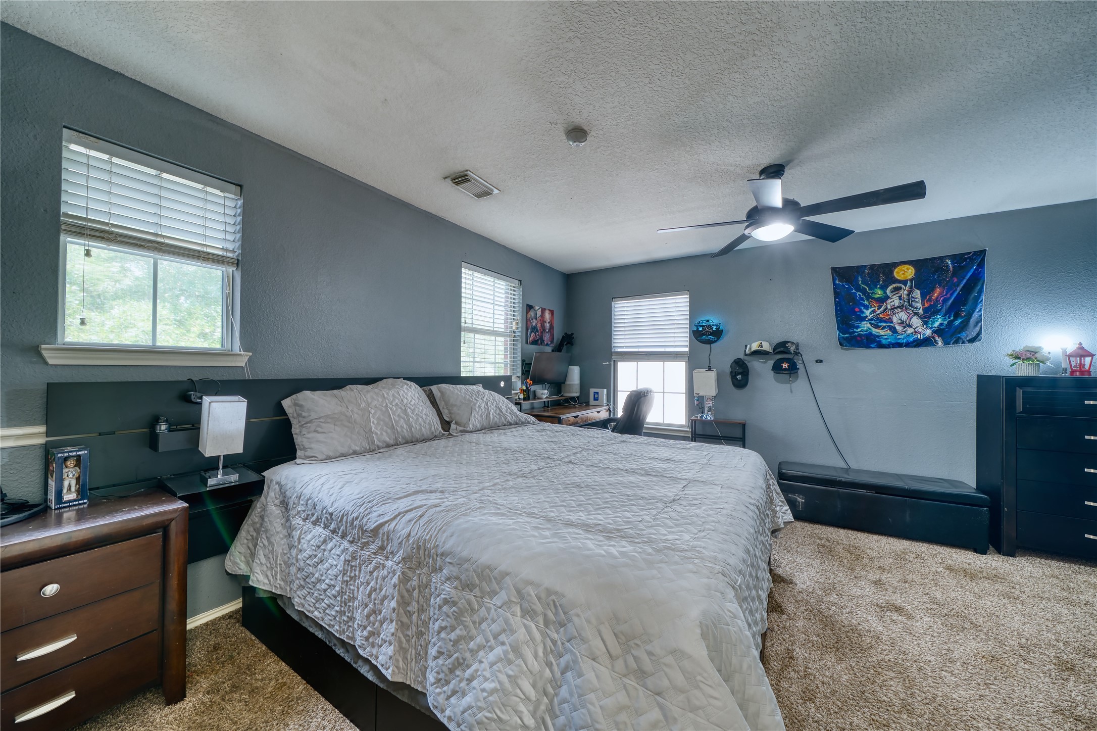 2210 Mountain Ranch Drive Houston, TX 77049 - Photo 26 of 36 a spacious bedroom with a bed a dresser next to a window