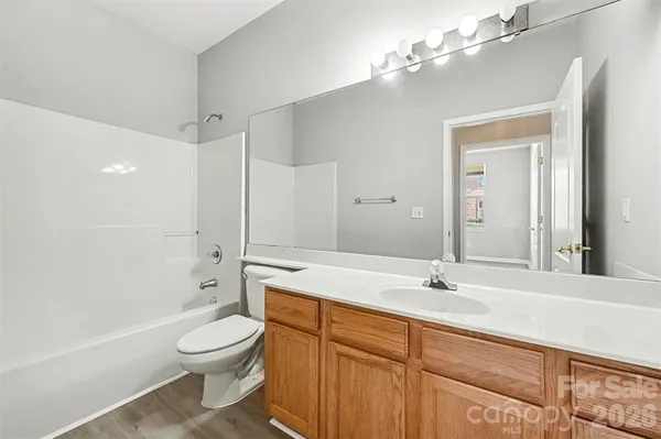 a bathroom with a sink a toilet and a large mirror