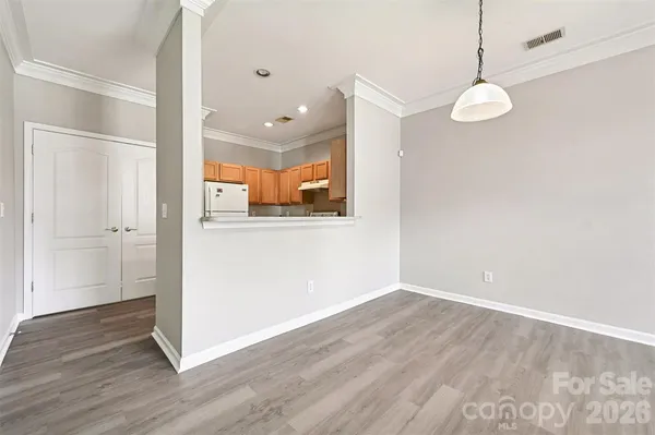 a view of a room with wooden floor and window