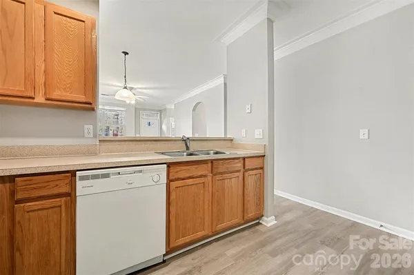 a kitchen with granite countertop white cabinets and white appliances