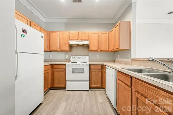 a kitchen with a white cabinets and white appliances