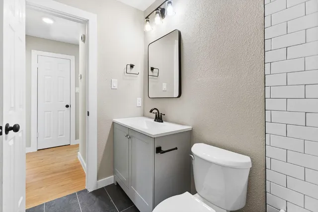 a white toilet sitting next to a bathroom sink