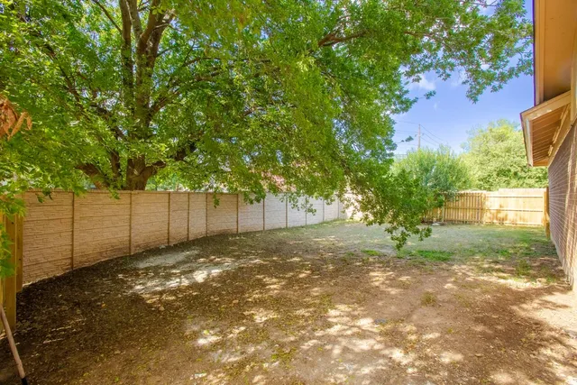 a backyard of a house with lots of green space