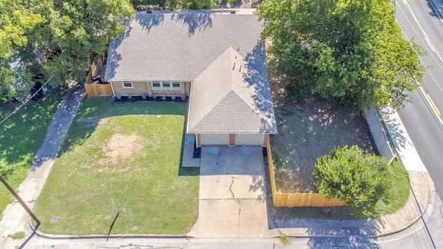 an aerial view of a house with outdoor space