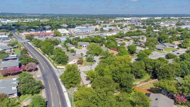 an aerial view of a house with a yard and garden