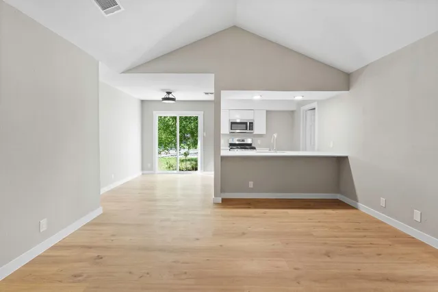 a view of wooden floor and windows in a room