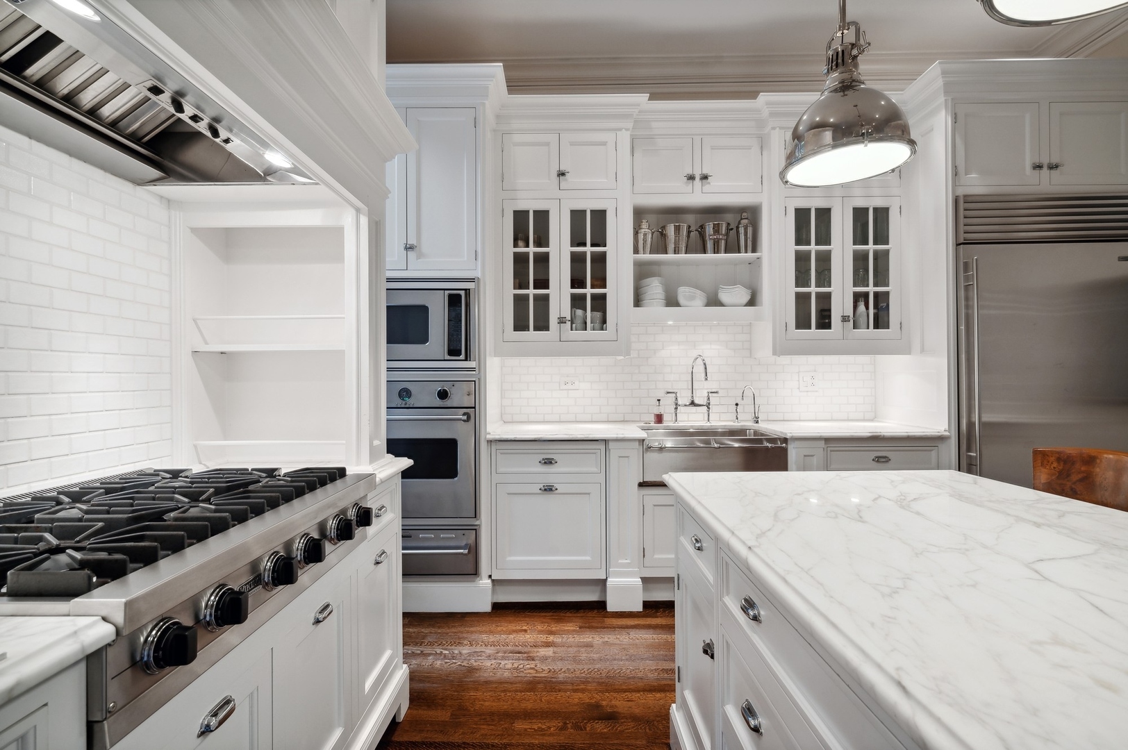 39 East Elm Street Chicago, IL 60611 - Photo 13 of 49 a kitchen with stainless steel appliances granite countertop a stove and a sink