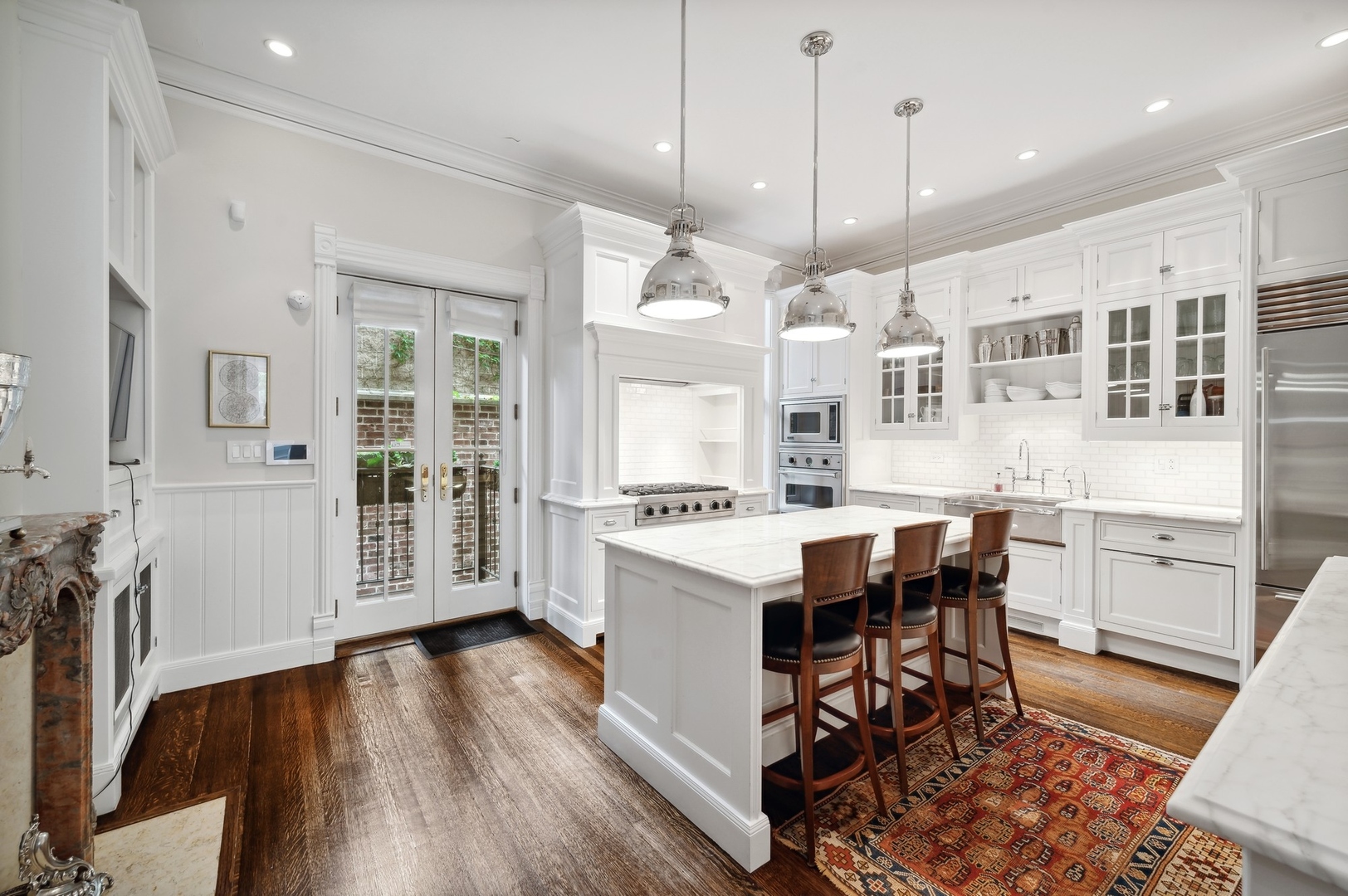 39 East Elm Street Chicago, IL 60611 - Photo 17 of 49 a kitchen with stainless steel appliances granite countertop a stove a refrigerator a kitchen island a table and chairs