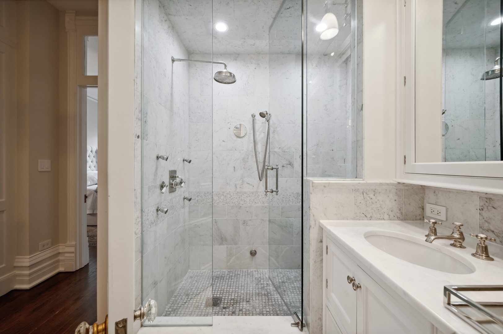 39 East Elm Street Chicago, IL 60611 - Photo 30 of 49 a bathroom with a shower sink and mirror