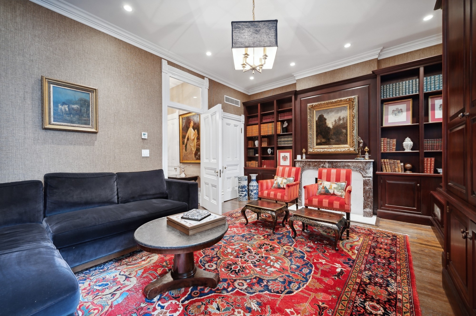 39 East Elm Street Chicago, IL 60611 - Photo 32 of 49 a living room with furniture a rug and a bookshelf
