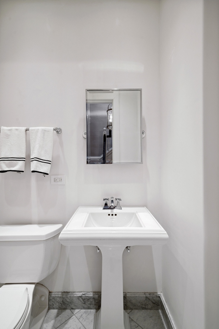 39 East Elm Street Chicago, IL 60611 - Photo 48 of 49 a bathroom with a sink and a toilet