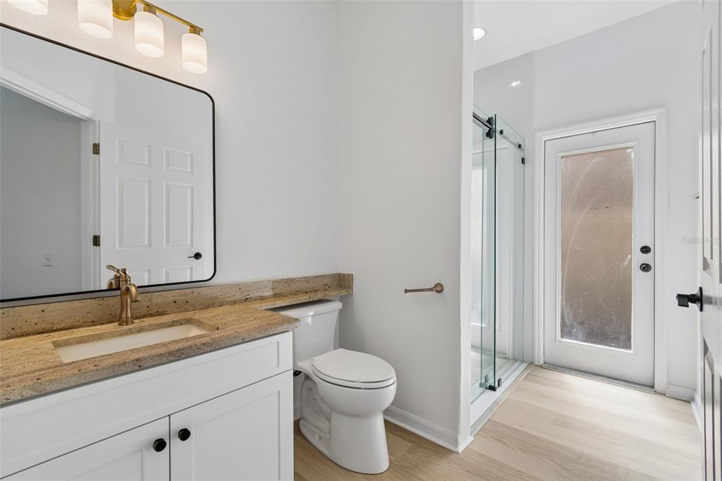 2300 Hannah Way South Dunedin, FL 34698 - Photo 18 of 49 a bathroom with a granite countertop sink toilet a mirror and a shower