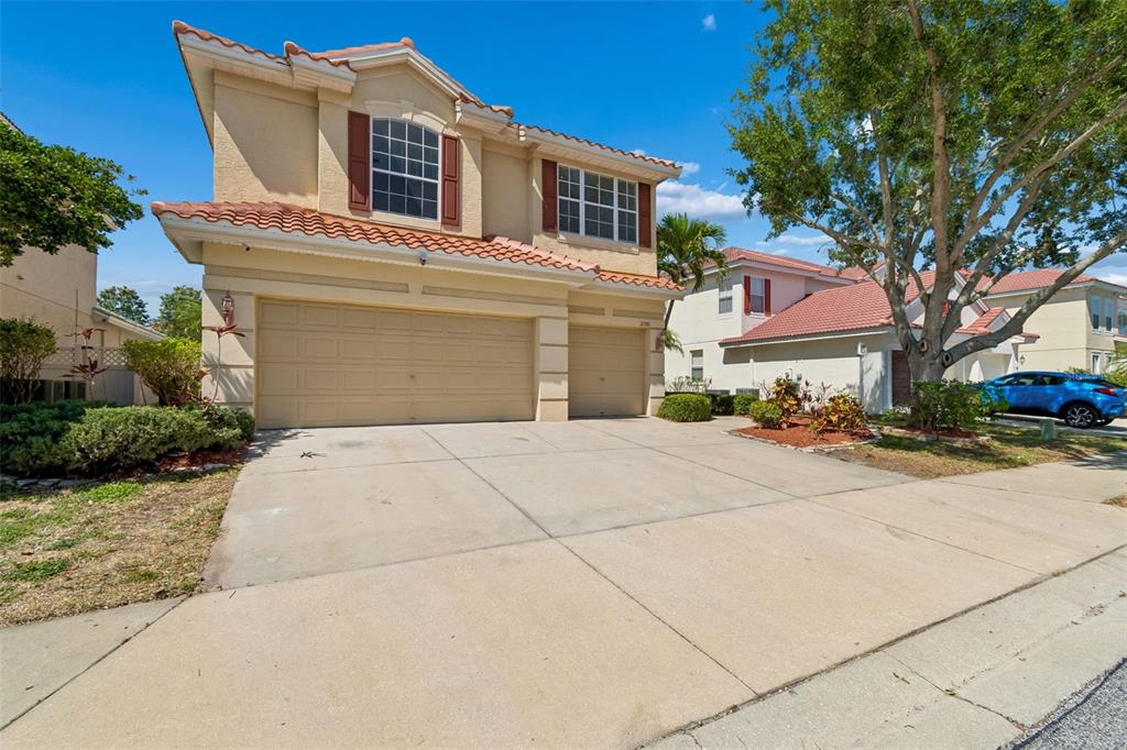 2300 Hannah Way South Dunedin, FL 34698 - Photo 2 of 49 a front view of a house with a yard and garage
