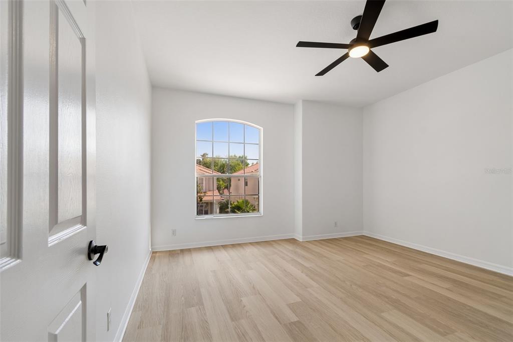 2300 Hannah Way South Dunedin, FL 34698 - Photo 31 of 49 an empty room with wooden floor and windows