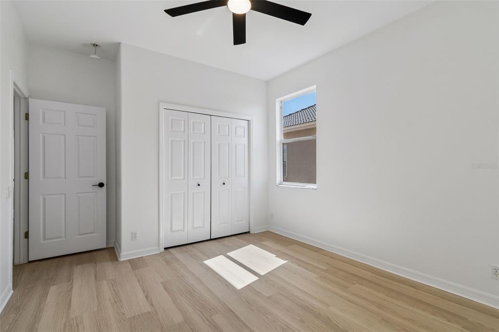 2300 Hannah Way South Dunedin, FL 34698 - Photo 35 of 49 a view of empty room with wooden floor and fan