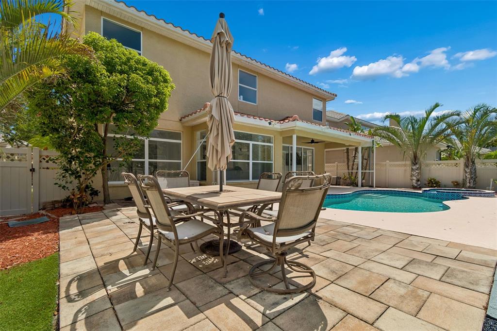 2300 Hannah Way South Dunedin, FL 34698 - Photo 46 of 49 a view of a patio with table and chairs with wooden floor and fence