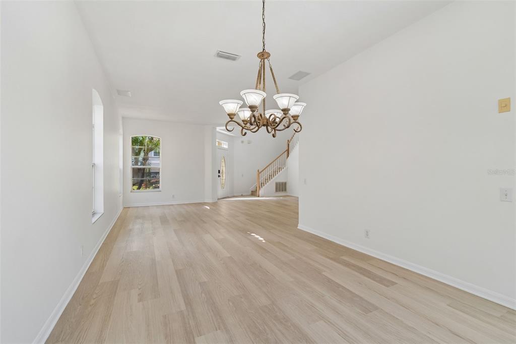 2300 Hannah Way South Dunedin, FL 34698 - Photo 5 of 49 a view of a room with wooden floor and chandelier
