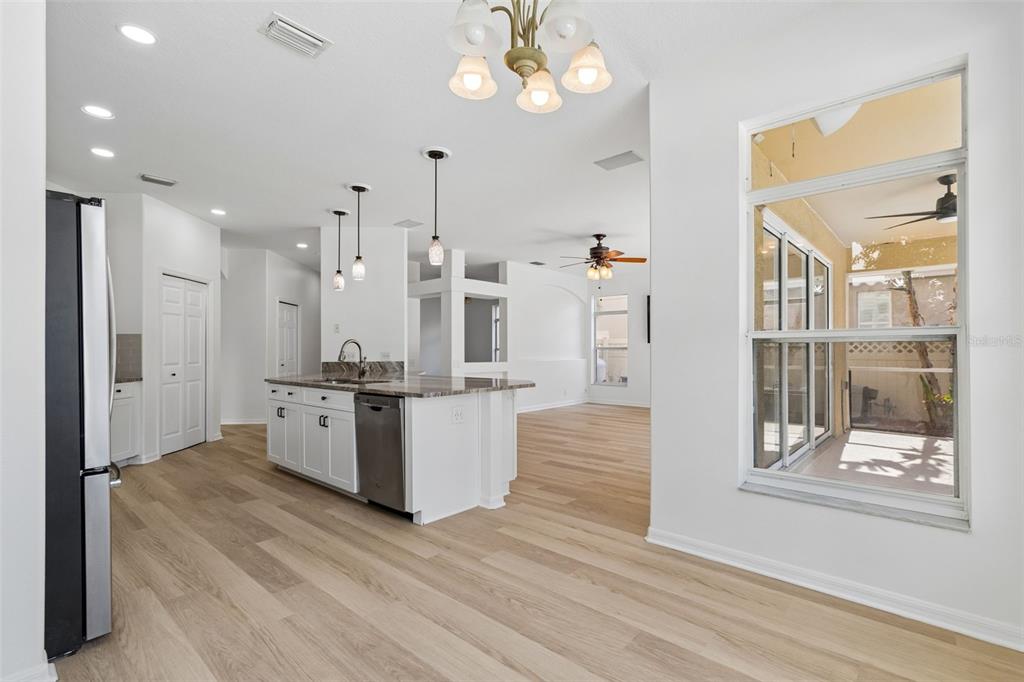 2300 Hannah Way South Dunedin, FL 34698 - Photo 9 of 49 a large room with chandelier fan and wooden floor