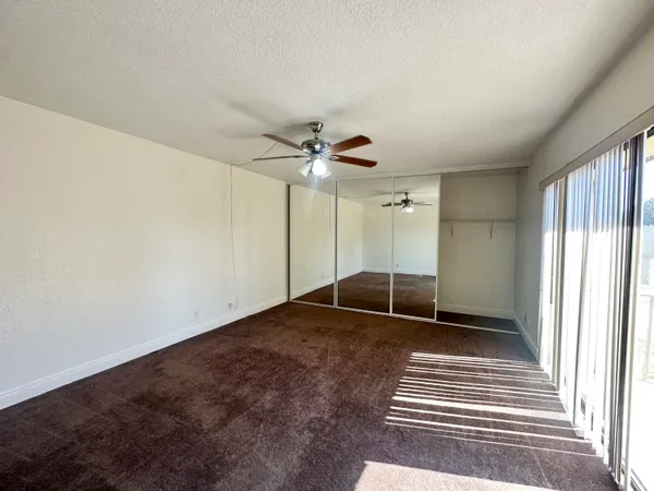 a view of a livingroom with a ceiling fan and window