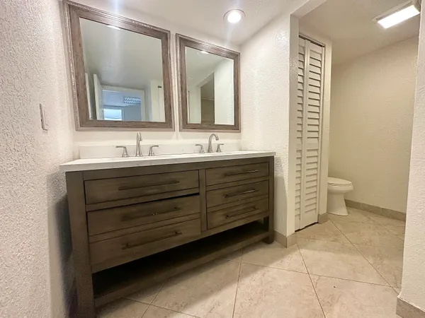 a bathroom with a double vanity sink and a mirror