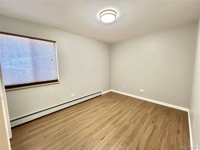 a view of an empty room with wooden floor