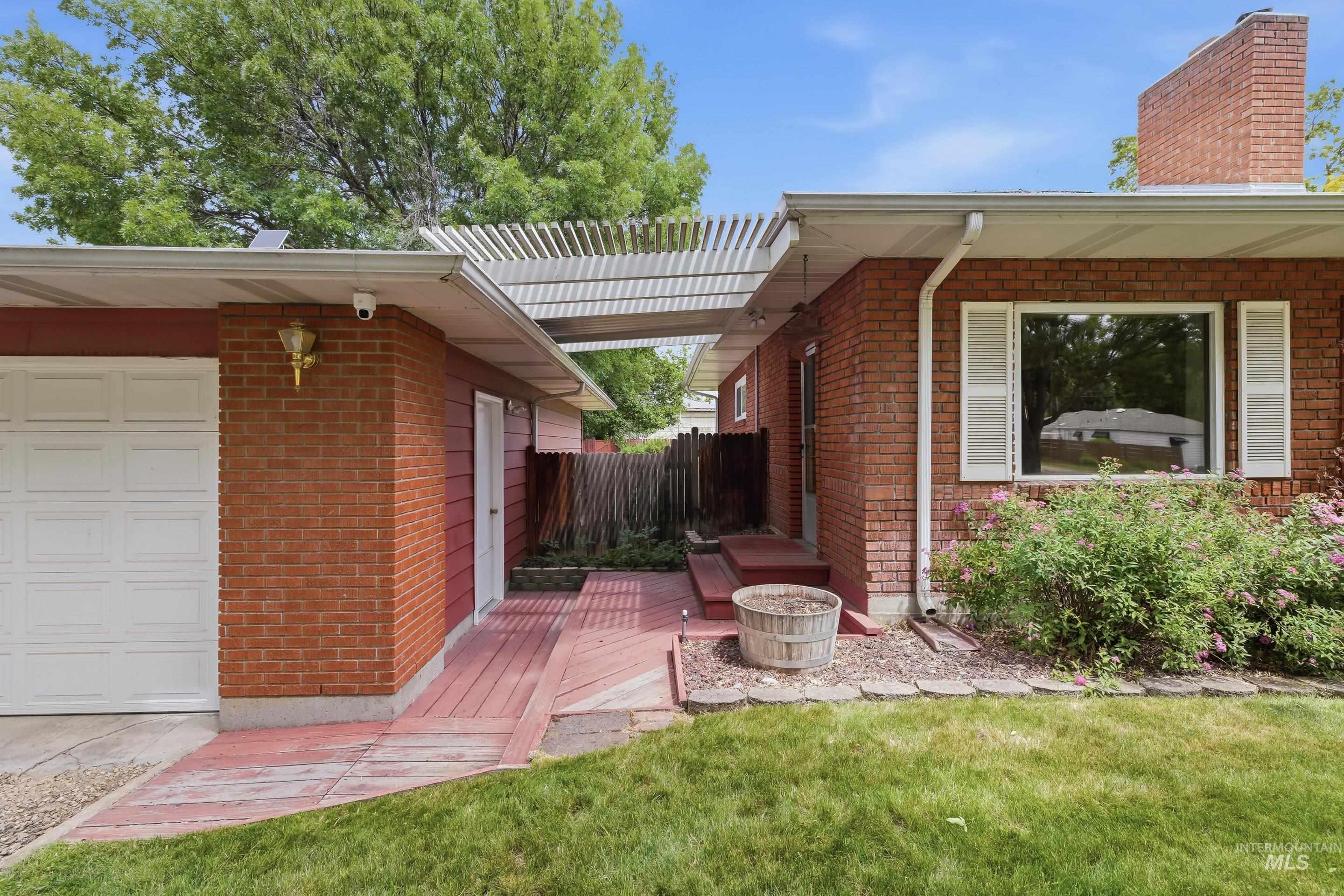 504 West Howe Street Boise, ID 83706 - Photo 4 of 47 Brick exterior with white garage door and white shutters