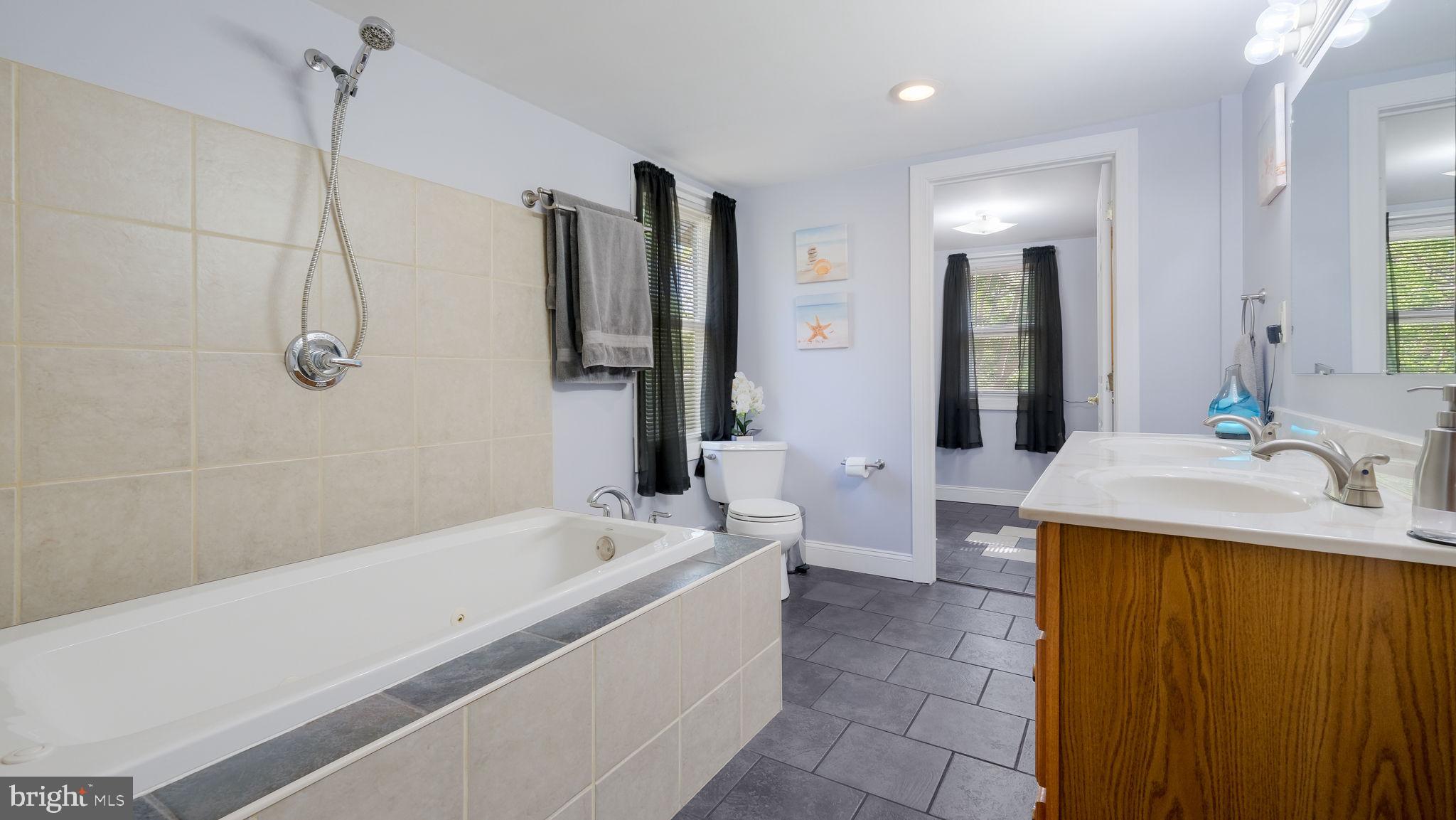 500 Prospect Road Warminster, PA 18974 - Photo 18 of 28 a bathroom with a tub sink and mirror