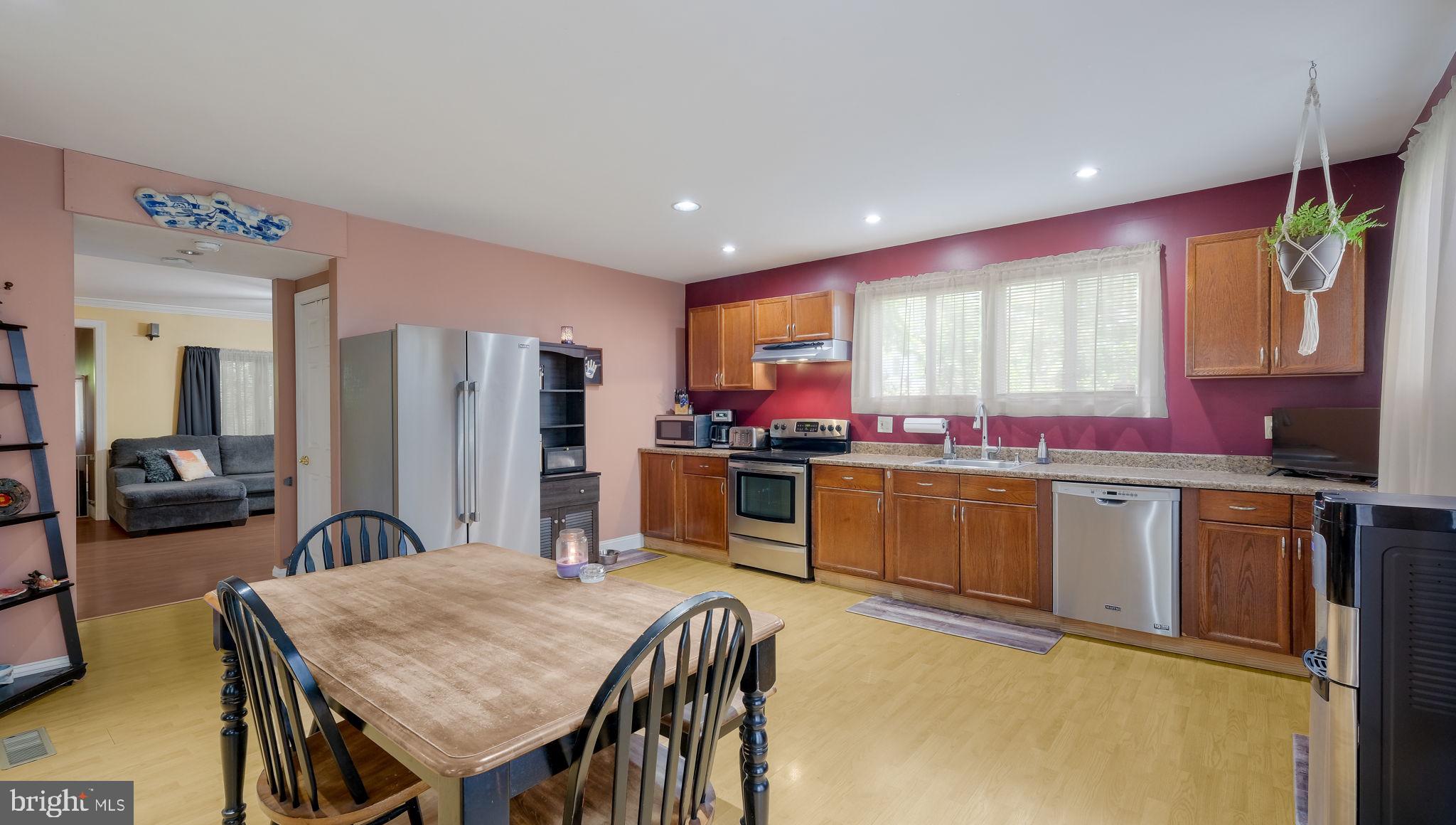 500 Prospect Road Warminster, PA 18974 - Photo 8 of 28 a kitchen with stainless steel appliances granite countertop a stove a sink dishwasher and a refrigerator with wooden floor
