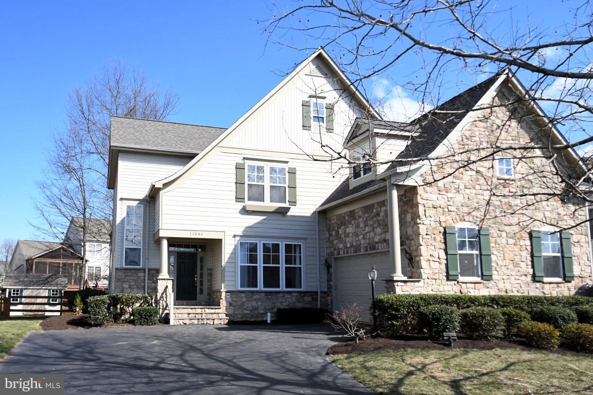 12845 Victory Lakes Loop Bristow, VA 20136 - Photo 1 of 27 a view of a white house next to a yard