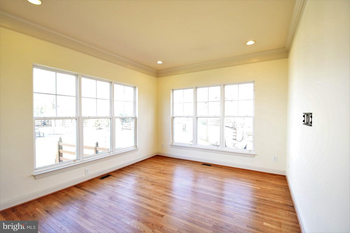 12845 Victory Lakes Loop Bristow, VA 20136 - Photo 11 of 27 an empty room with wooden floor and windows
