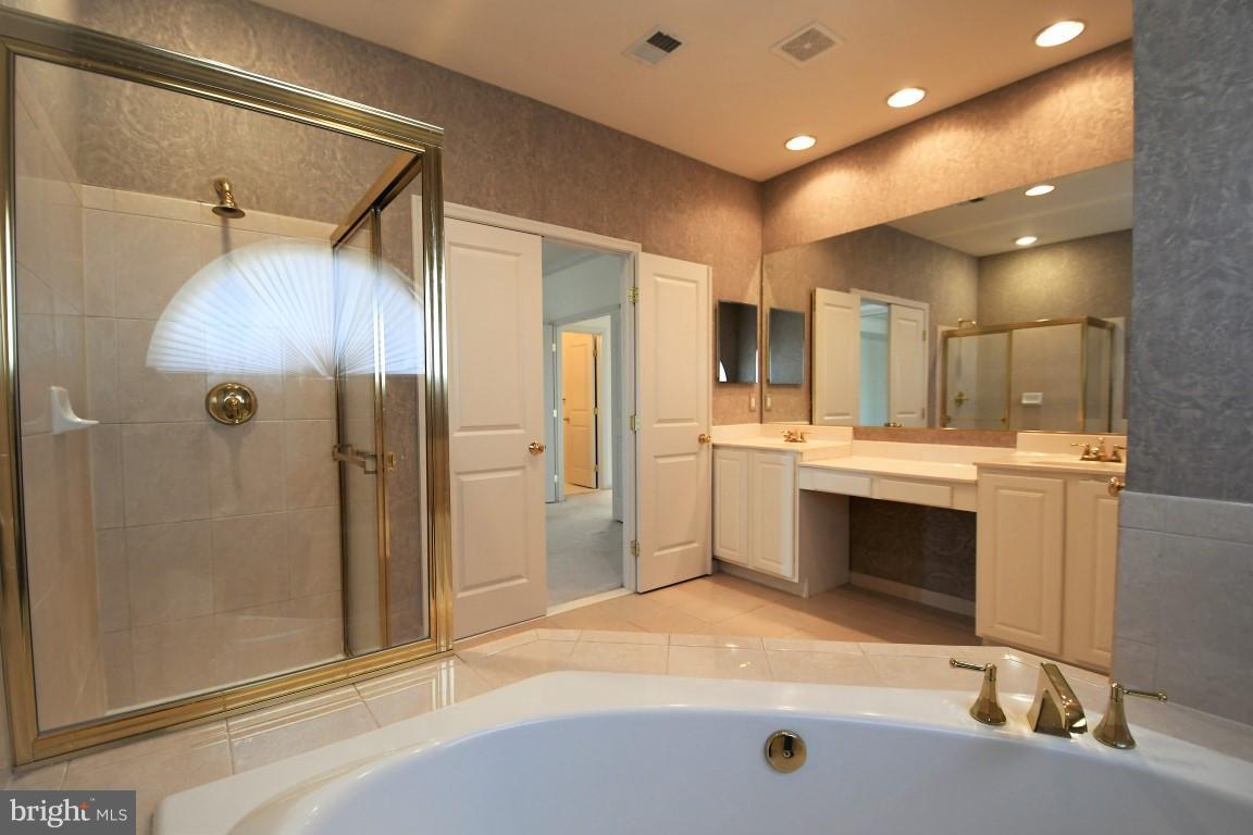12845 Victory Lakes Loop Bristow, VA 20136 - Photo 13 of 27 a bathroom with a sink a toilet a mirror and shower