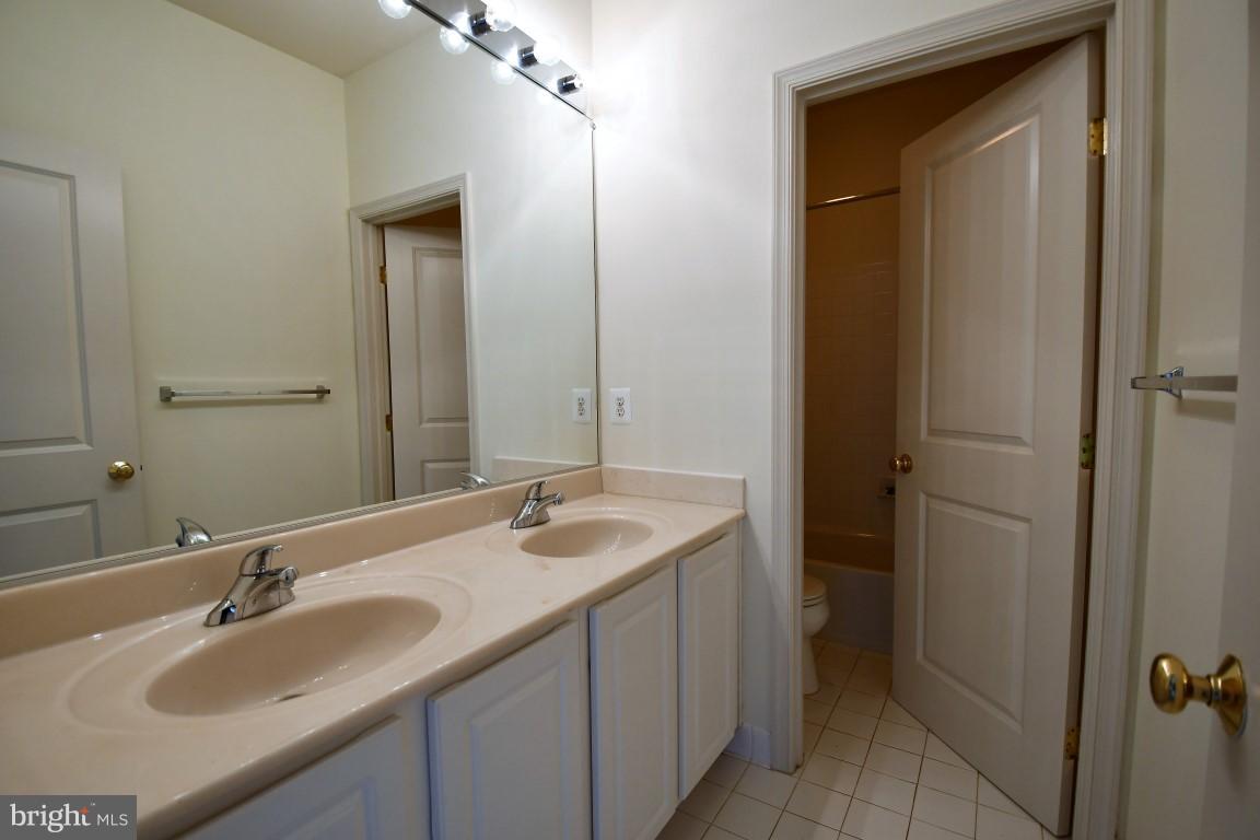 12845 Victory Lakes Loop Bristow, VA 20136 - Photo 16 of 27 a bathroom with a sink and a mirror