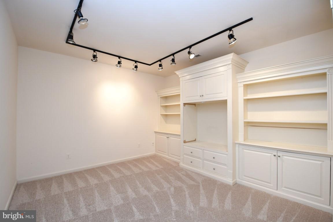 12845 Victory Lakes Loop Bristow, VA 20136 - Photo 20 of 27 a view of walk in closet with empty racks