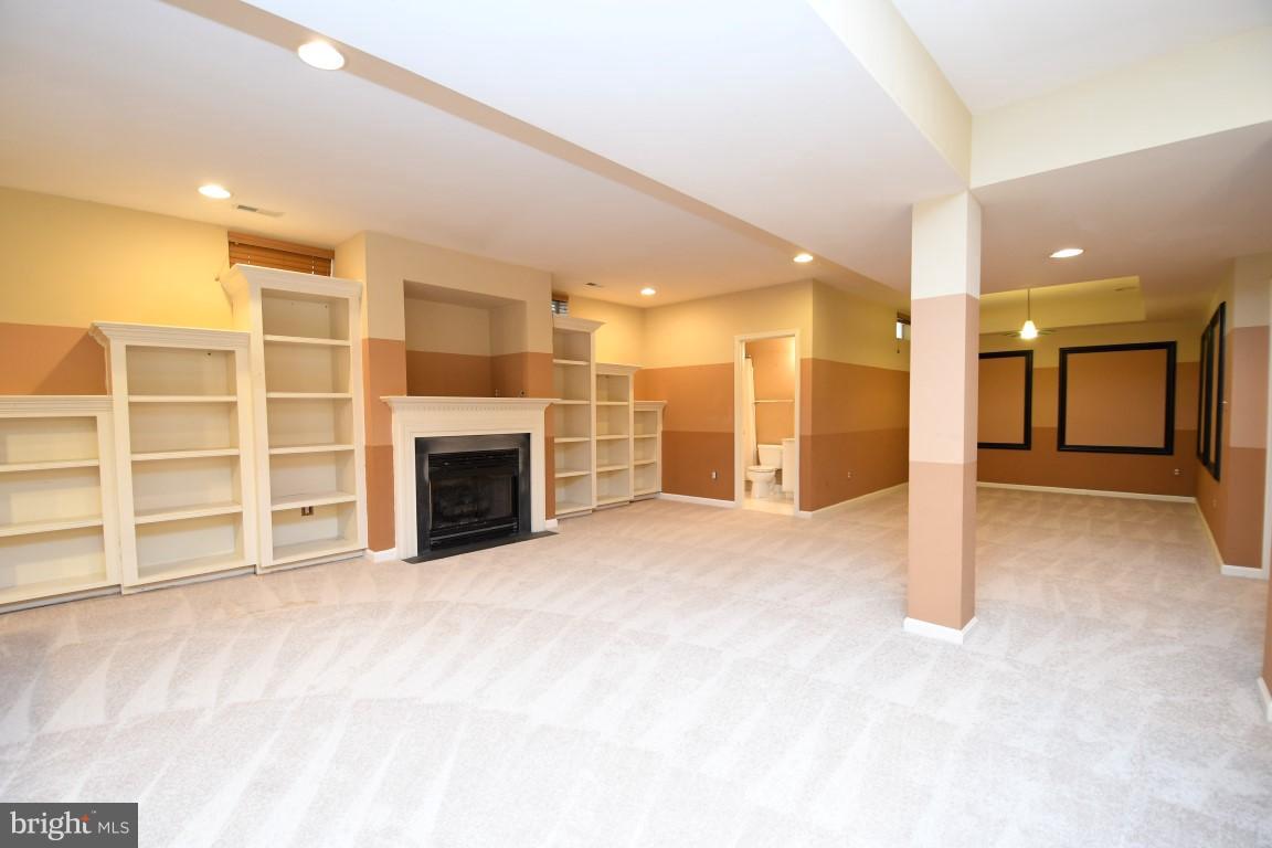 12845 Victory Lakes Loop Bristow, VA 20136 - Photo 21 of 27 a view of an empty room with a fireplace and cabinet