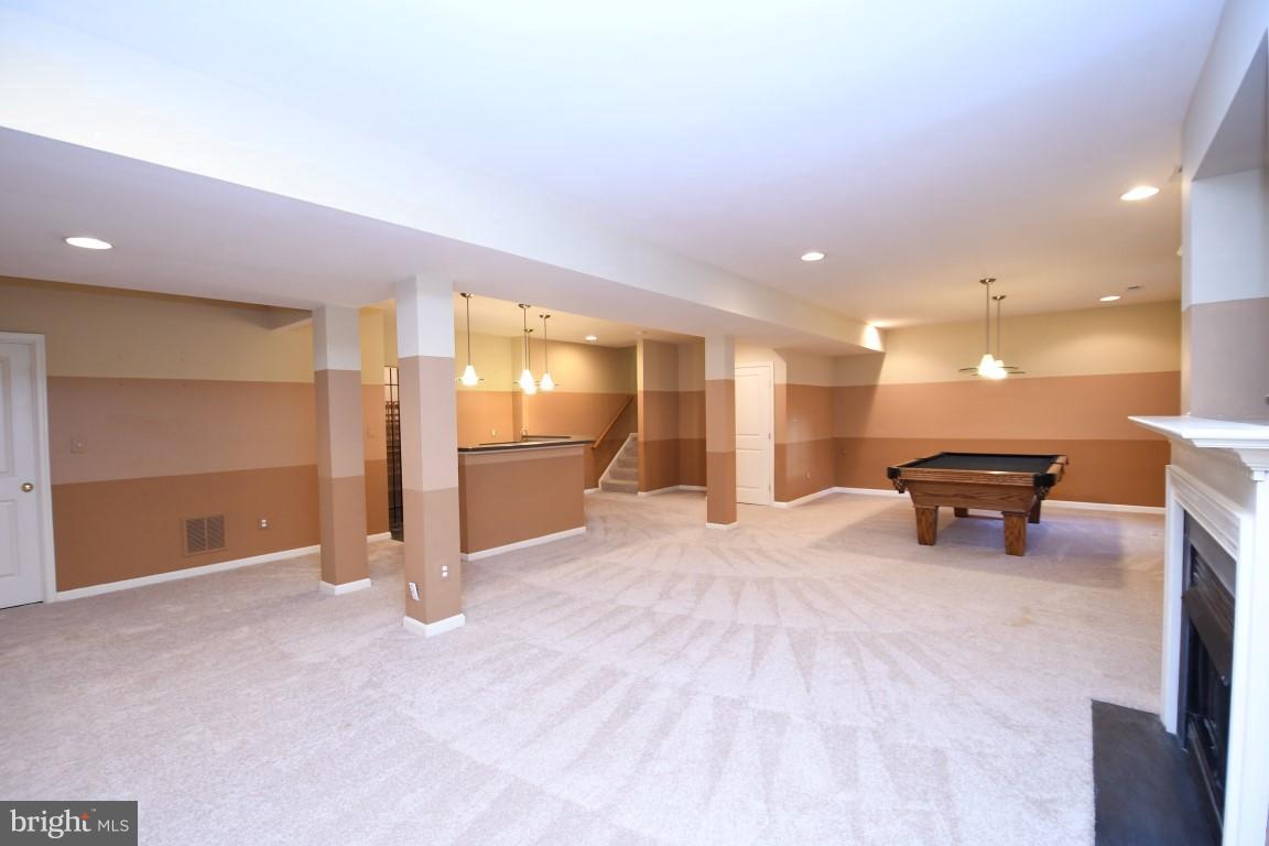12845 Victory Lakes Loop Bristow, VA 20136 - Photo 22 of 27 a view of a livingroom with wooden floor and furniture