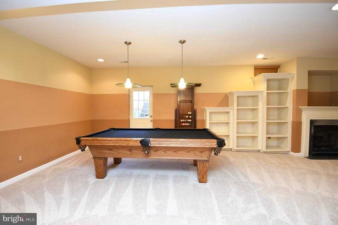12845 Victory Lakes Loop Bristow, VA 20136 - Photo 23 of 27 a room with pool table and fireplace