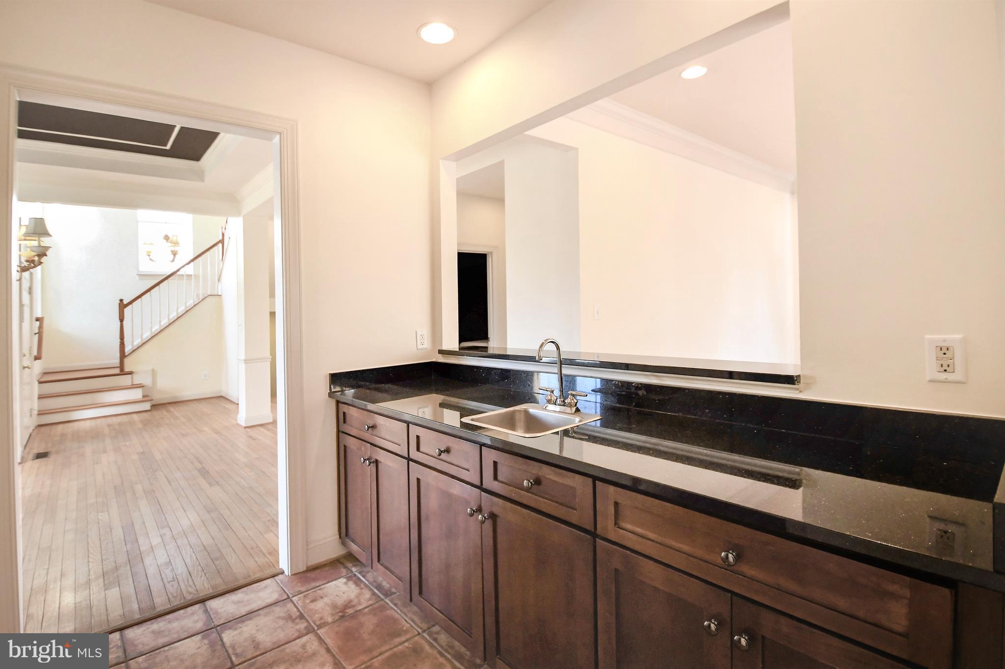 12845 Victory Lakes Loop Bristow, VA 20136 - Photo 6 of 27 a kitchen with a sink and a mirror