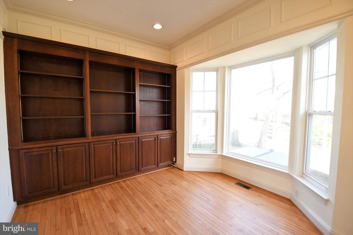 12845 Victory Lakes Loop Bristow, VA 20136 - Photo 10 of 27 a view of an empty room with a window and wooden floor