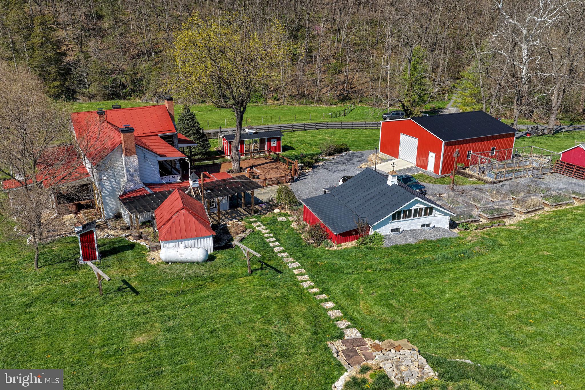 989 Swover Creek Road Edinburg, VA 22824 - Photo 7 of 132 an aerial view of a house with garden space and trees