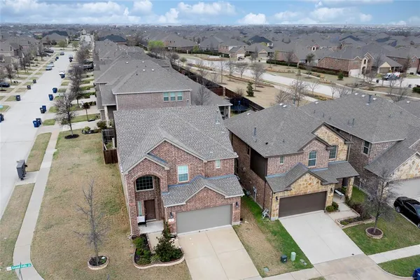 an aerial view of a house with a yard