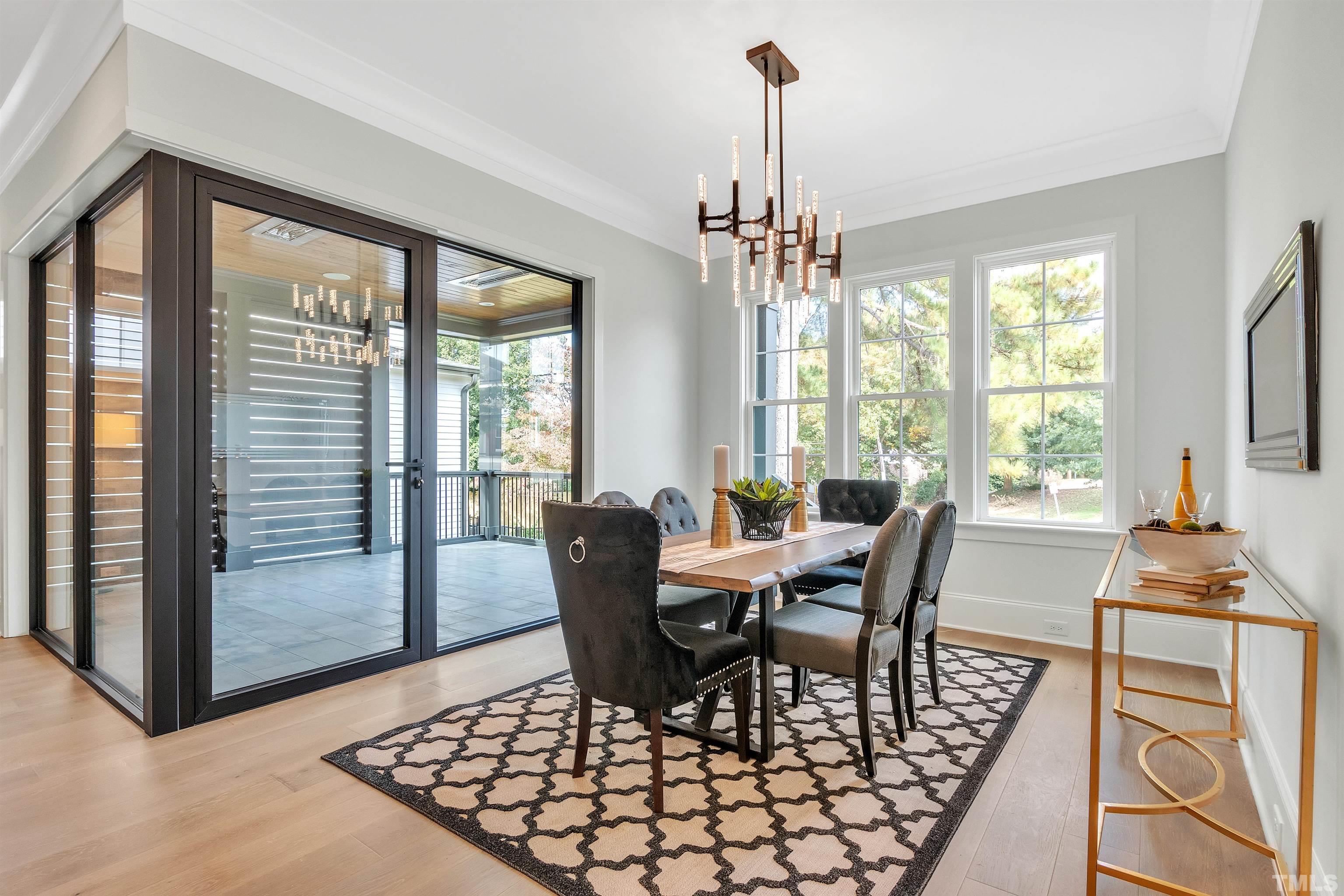 2000 Pine Drive Raleigh, NC 27608 - Photo 19 of 39 a view of a dining room with furniture wooden floor and a chandelier