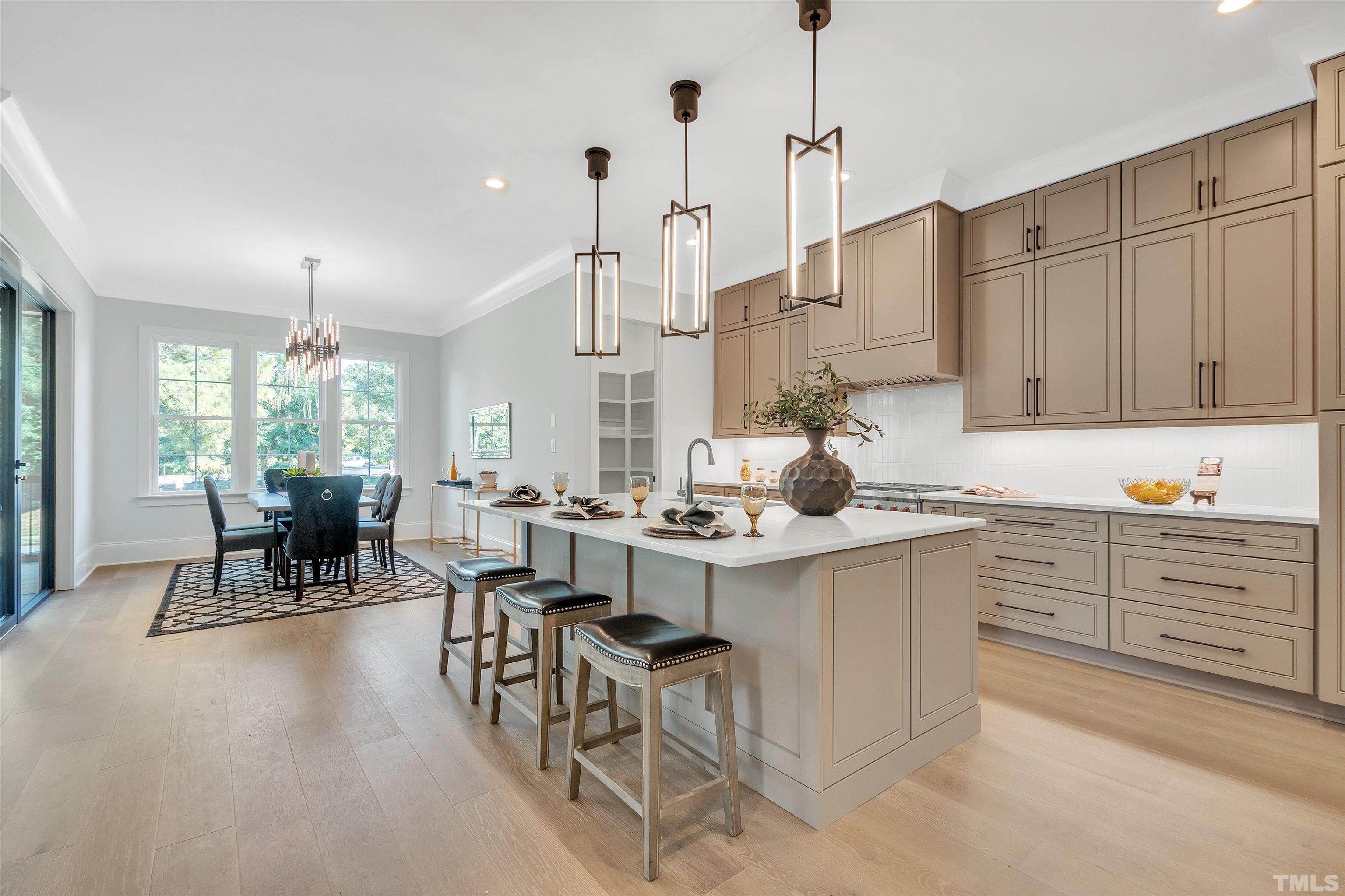 2000 Pine Drive Raleigh, NC 27608 - Photo 23 of 39 a kitchen with center island table and chairs in it