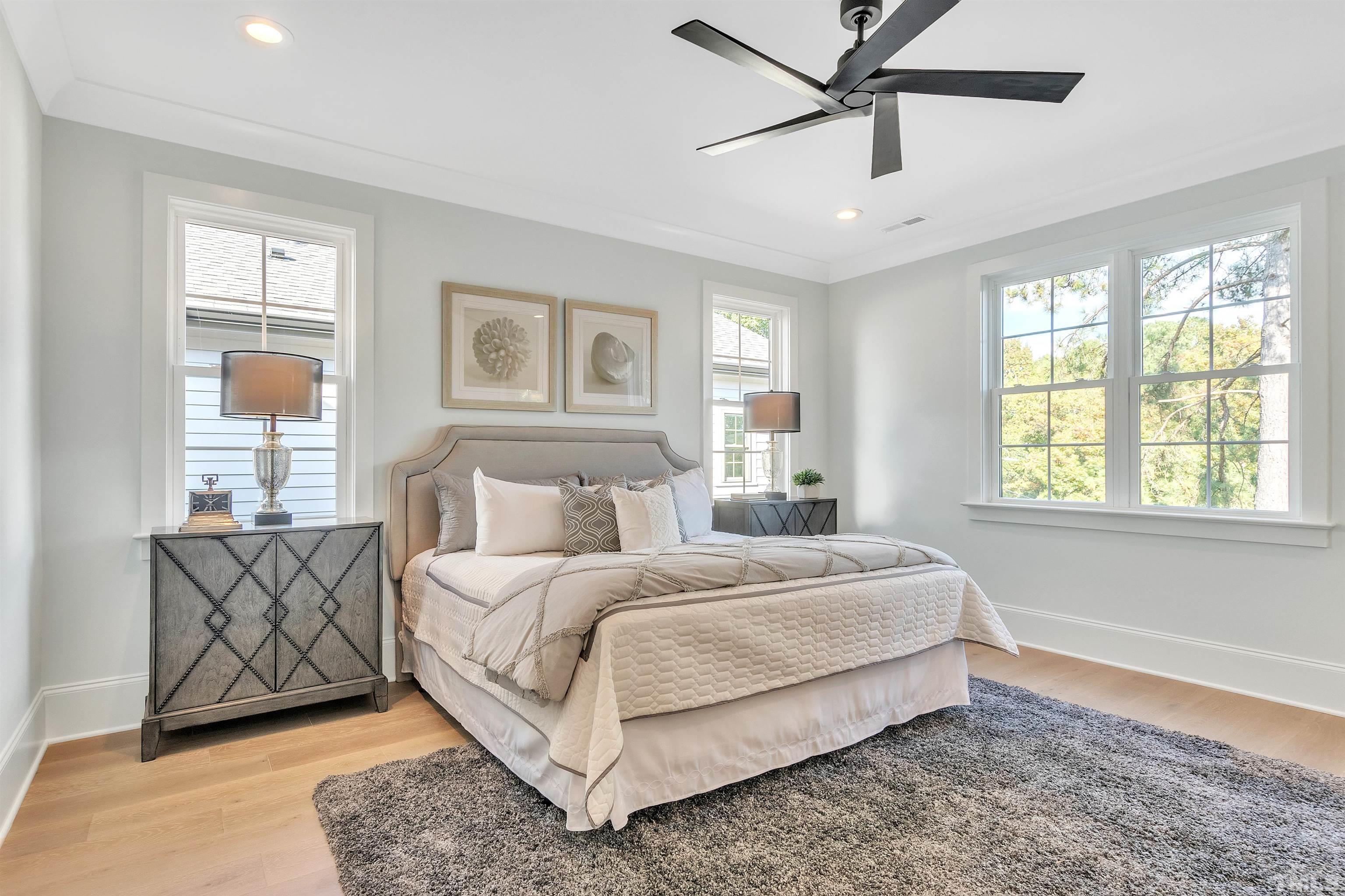 2000 Pine Drive Raleigh, NC 27608 - Photo 26 of 39 a a spacious bedroom with a bed a couch and windows