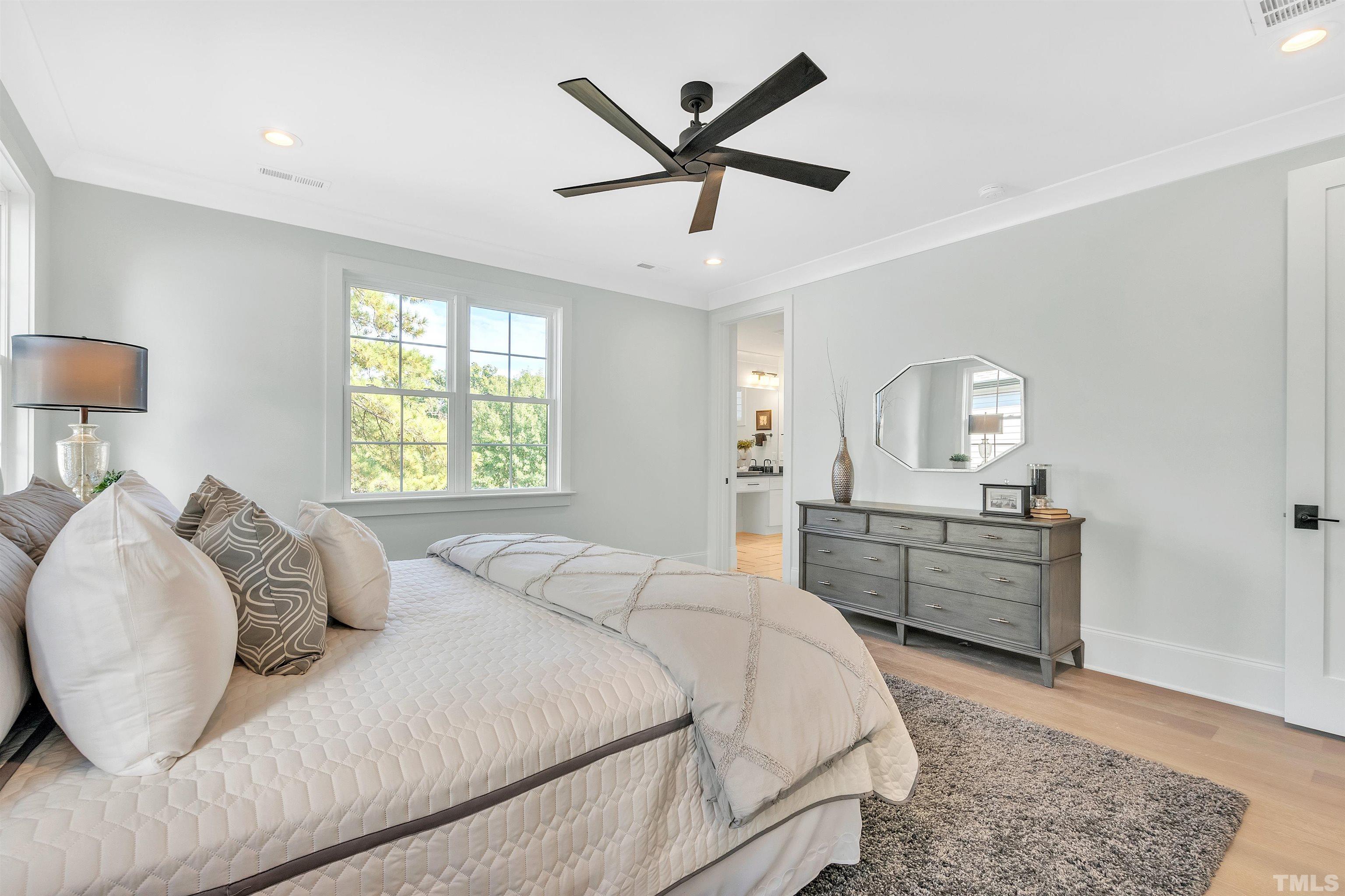 2000 Pine Drive Raleigh, NC 27608 - Photo 27 of 39 a bedroom with a large bed and a chandelier