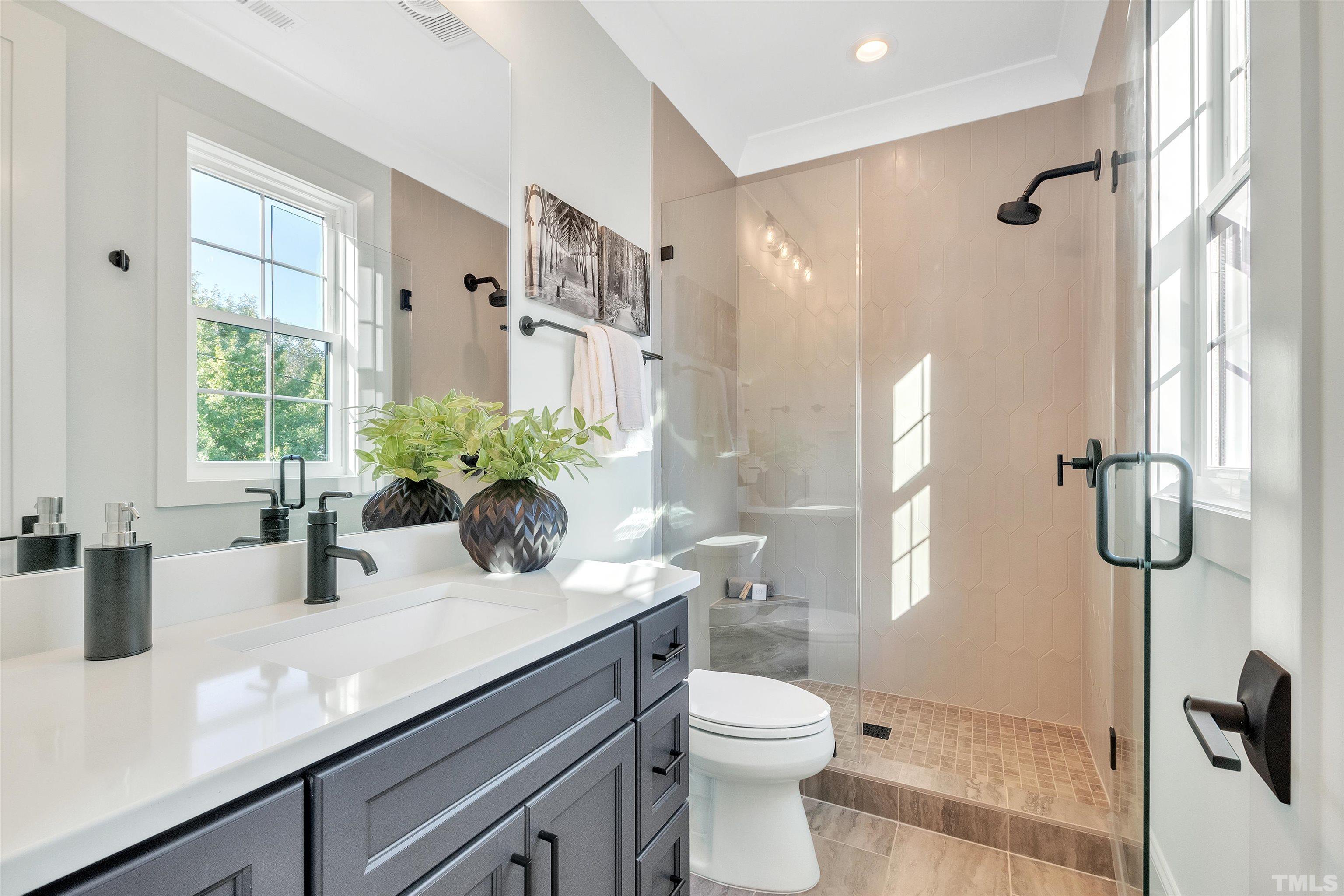 2000 Pine Drive Raleigh, NC 27608 - Photo 31 of 39 a bathroom with a sink a toilet and shower