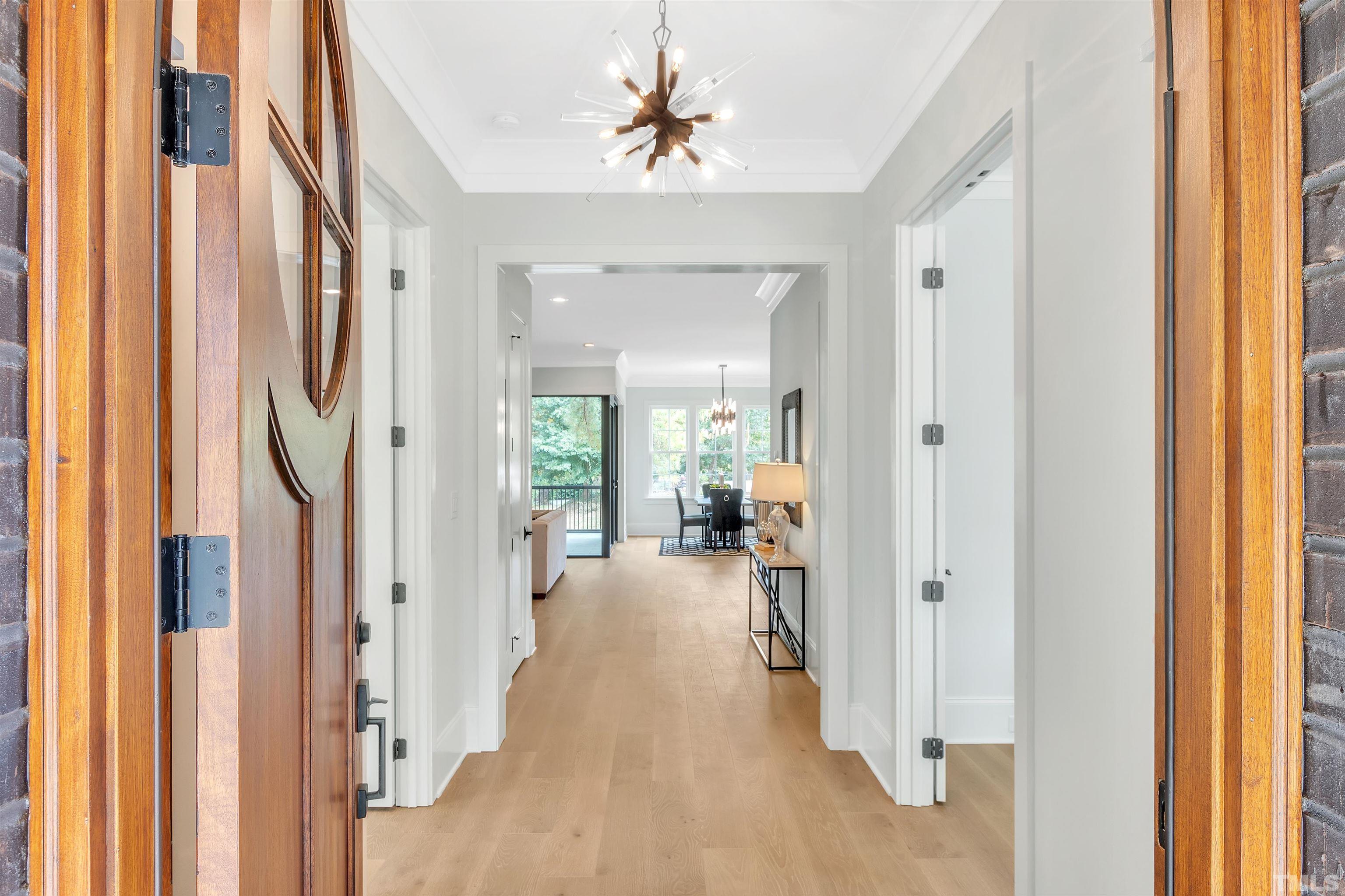 2000 Pine Drive Raleigh, NC 27608 - Photo 9 of 39 a view of a hallway with a livingroom and a dinning area windows