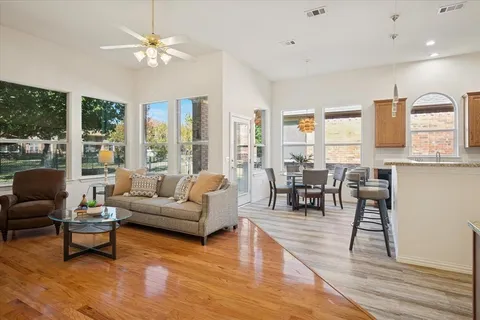 a living room with furniture dining table and a large window