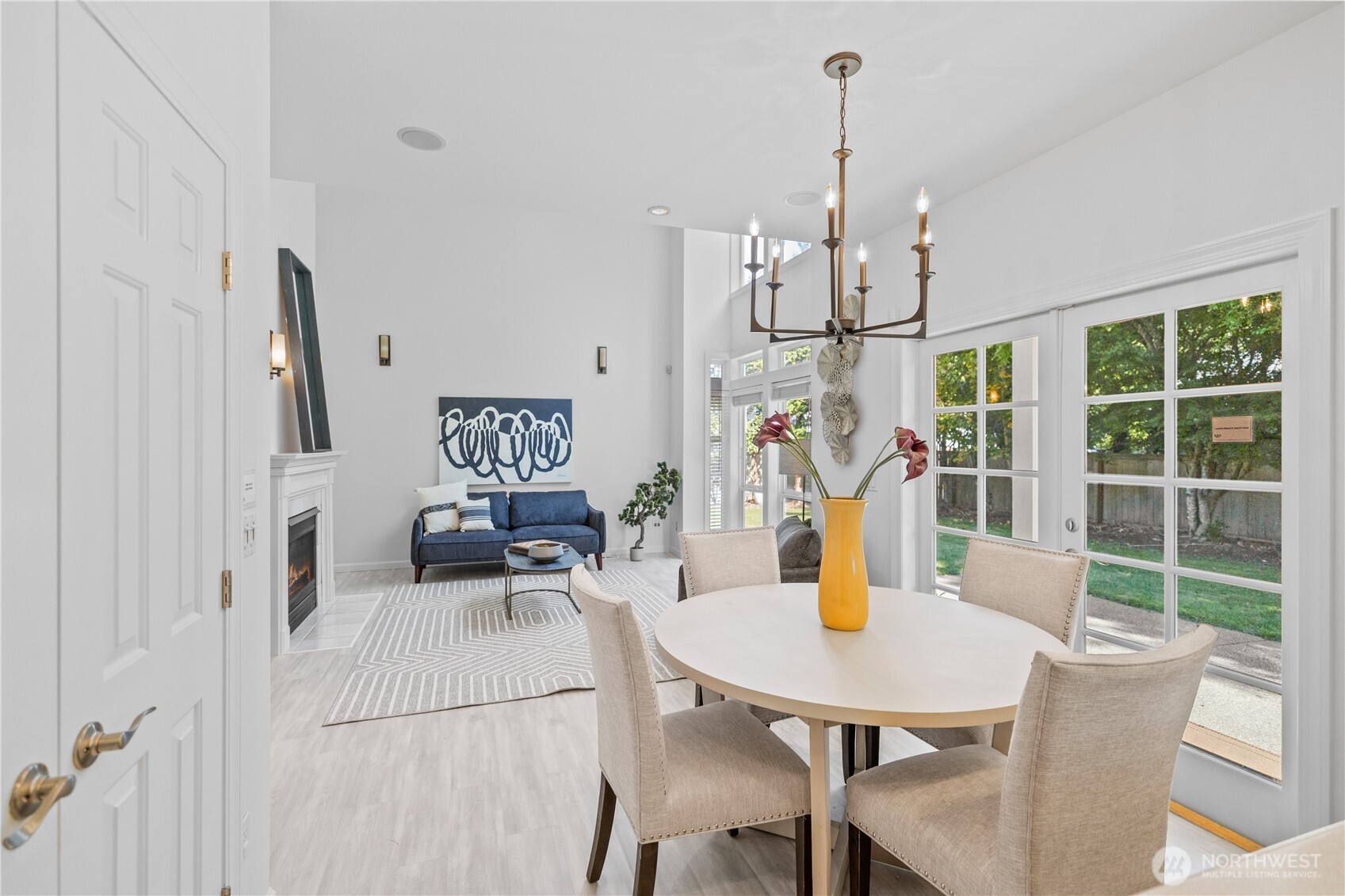 5217 76th Ave Court West University Place, WA 98467 - Photo 15 of 36 a view of a dining room with furniture a chandelier and large windows